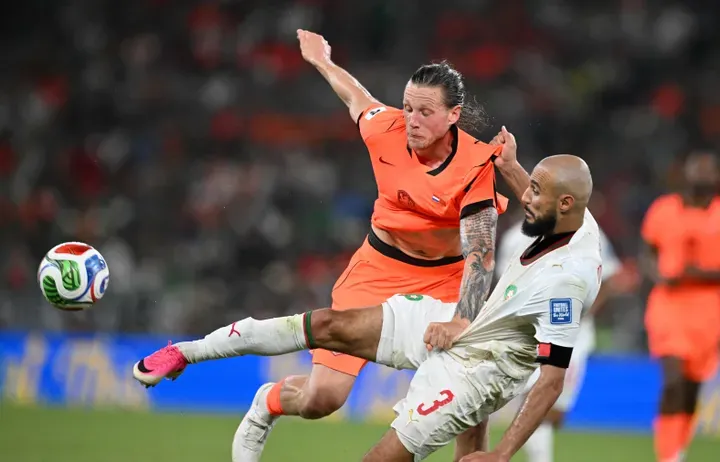 TOPSHOT - Netherlands' forward #09 Wout Weghorst and Morocco's defender #03 Noussair Mazraoui fight for the ball during the 2026 World Cup round of 32 football match between the Netherlands and Morocco at the Monterrey Stadium in Guadalupe on June 29, 2026. (Photo by CARL DE SOUZA / AFP)