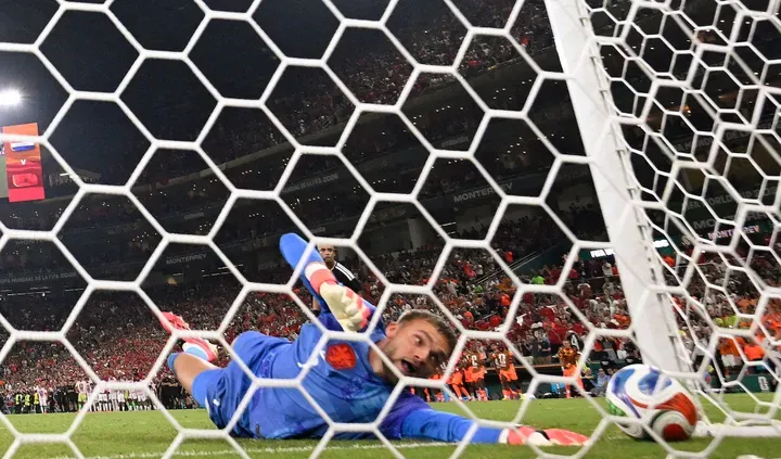TOPSHOT - Netherlands goalkeeper #01 Bart Verbruggen concedes a penalty goal by Morocco forward #09 Soufiane Rahimi during the penalty shootout of the 2026 World Cup round of 32 football match between the Netherlands and Morocco at the Monterrey Stadium in Guadalupe on June 29, 2026. (Photo by Alfredo ESTRELLA / AFP)
