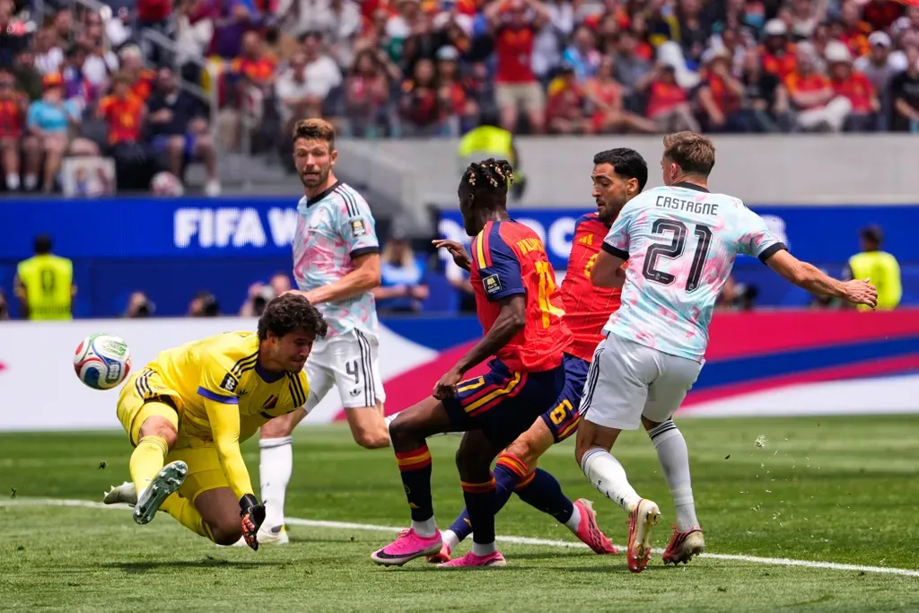 Spain's Mikel Merino (6) scores his side's second goal as Belgium goalkeeper Senne Lammens (12) defends as during the World Cup quarterfinal soccer match between Spain and Belgium in Inglewood, Calif., near Los Angeles, Friday, July 10, 2026. (AP Photo/Mark J. Terrill)