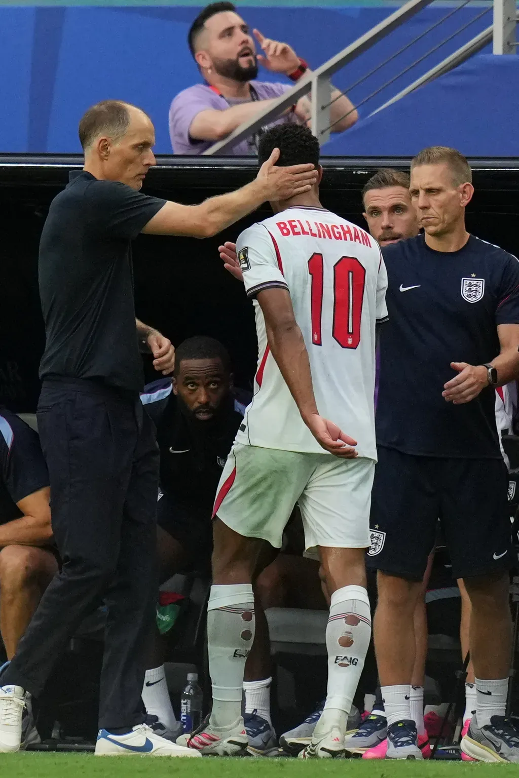 England's Jude Bellingham receives congratulations from the coach Thomas Tuchel after being substituted during the World Cup quarterfinal match against Norway in Miami Gardens, Fla., Saturday, July 11, 2026. (AP Photo/Lynne Sladky)