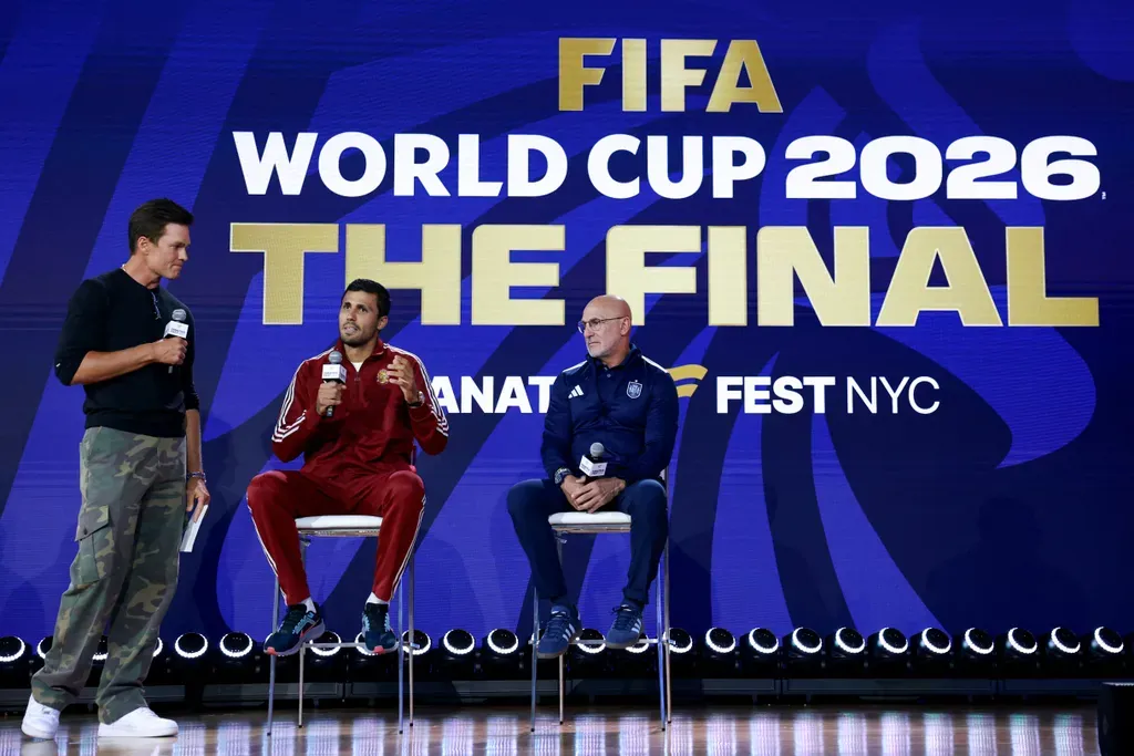 NEW YORK, NEW YORK - JULY 17: American football player Tom Brady speaks with Rodri #16 of Spain and Luis De La Fuente, Head Coach of Spain, during a press conference ahead of the FIFA World Cup 2026 Final at Fanatics Fest at Javits Center on July 17, 2026 in New York, New York. Elsa/Getty Images/AFP (Photo by ELSA / GETTY IMAGES NORTH AMERICA / Getty Images via AFP)